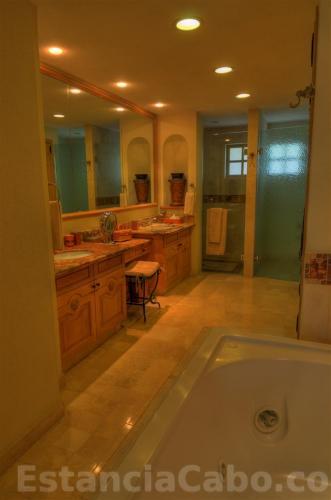 the dual sink master bath in villa 1303 with a small vanity area.